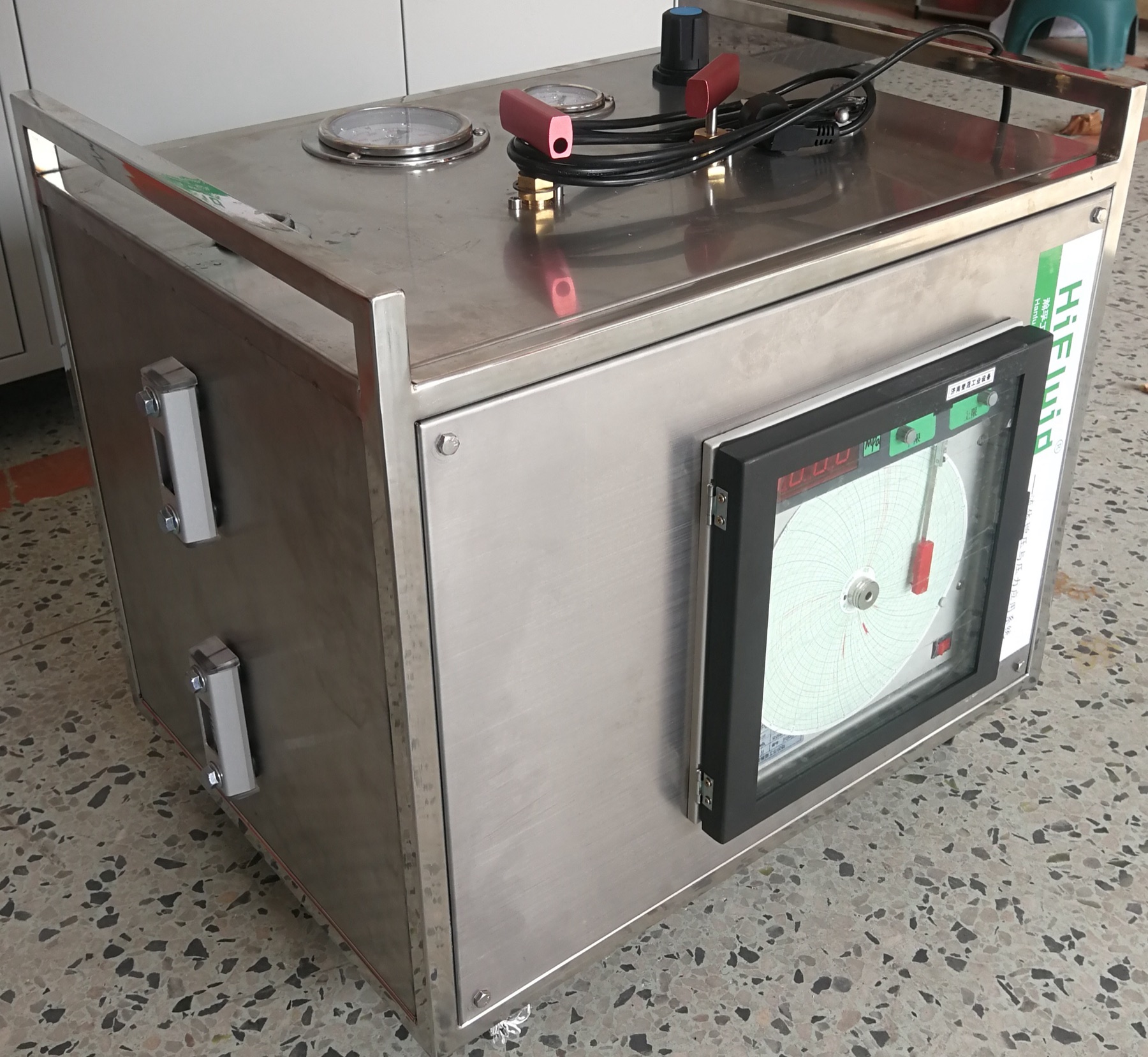 Side view of hydro-pneumatic booster system with pressure chart recorder